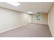 Spacious basement with neutral walls, carpet, and natural light from a window at 610 Golden Meadows Ln, Suwanee, GA 30024