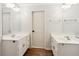 Bathroom features dual vanities with modern fixtures and wood-look floors at 610 Golden Meadows Ln, Suwanee, GA 30024