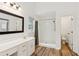 Bright bathroom features modern vanity, walk-in shower, and a view of the toilet behind an open door at 610 Golden Meadows Ln, Suwanee, GA 30024