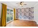 Bedroom featuring a window, hardwood floors, a ceiling fan, and floral wallpaper at 610 Golden Meadows Ln, Suwanee, GA 30024