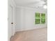 Bright bedroom with a bright window, ceiling fan, and neutral carpet at 610 Golden Meadows Ln, Suwanee, GA 30024