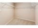 Walk-in closet featuring wire shelving and neutral carpet at 610 Golden Meadows Ln, Suwanee, GA 30024