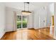 Elegant dining room with hardwood floors, a large window, and a stunning chandelier at 610 Golden Meadows Ln, Suwanee, GA 30024