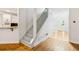 Bright entryway featuring hardwood floors, a staircase, and views of the kitchen at 610 Golden Meadows Ln, Suwanee, GA 30024