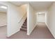 Hallway features carpet, access to other rooms, and a stairwell at 610 Golden Meadows Ln, Suwanee, GA 30024