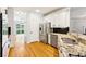 Contemporary kitchen with stainless steel appliances, granite countertops, and hardwood floors at 610 Golden Meadows Ln, Suwanee, GA 30024