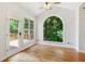 Living room features a ceiling fan, an arched window and a door leading to a deck at 610 Golden Meadows Ln, Suwanee, GA 30024