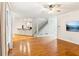 Open-concept living space with hardwood floors, a staircase, and a view into the kitchen at 610 Golden Meadows Ln, Suwanee, GA 30024
