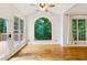 Bright sunroom featuring hardwood floors, a vaulted ceiling, and large windows overlooking greenery at 610 Golden Meadows Ln, Suwanee, GA 30024