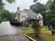 View of the home's rear, showing a spacious wooden deck overlooking the backyard at 1640 Settindown Dr, Roswell, GA 30075