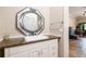 Half bathroom featuring a granite countertop, decorative mirror, and white vanity with ample storage at 1640 Settindown Dr, Roswell, GA 30075