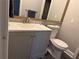 Cozy bathroom featuring a modern vanity, toilet, and decorative mirror with an elaborate gold frame at 1640 Settindown Dr, Roswell, GA 30075