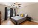 Bedroom with hardwood floors, gray walls, gray bedspread, and large window view at 1640 Settindown Dr, Roswell, GA 30075