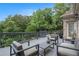Outdoor deck features modern patio furniture, green foliage, and relaxing space for outdoor enjoyment at 1640 Settindown Dr, Roswell, GA 30075