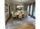 Bright dining room features a modern chandelier, neutral decor, and a stylish area rug over hardwood floors at 1640 Settindown Dr, Roswell, GA 30075