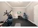 Home gym featuring exercise equipment, a mounted TV, and rubber flooring for a great workout space at 1640 Settindown Dr, Roswell, GA 30075