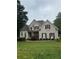 Charming two-story home with brick and stone exterior and well-manicured front lawn at 1640 Settindown Dr, Roswell, GA 30075