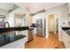 Well-lit kitchen features stainless steel appliances, granite countertops, and white cabinets at 1640 Settindown Dr, Roswell, GA 30075