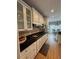 Well-equipped kitchen featuring white cabinets, granite countertops, stainless steel appliances, and a gas cooktop at 1640 Settindown Dr, Roswell, GA 30075