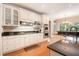 Well-lit kitchen with stainless steel appliances, granite counters, and white cabinets for a clean, modern look at 1640 Settindown Dr, Roswell, GA 30075