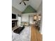 Inviting living room with a vaulted ceiling, a fireplace, and hardwood floors, perfect for entertaining and relaxing at 1640 Settindown Dr, Roswell, GA 30075