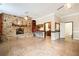 Open-concept living room boasts a stone fireplace, tile floors, and seamless kitchen/bathroom access at 1640 Settindown Dr, Roswell, GA 30075