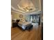Spacious main bedroom with tray ceiling, hardwood floors, and sitting area at 1640 Settindown Dr, Roswell, GA 30075
