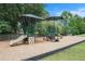 Community playground with slides, climbing wall, and covered seating at 1640 Settindown Dr, Roswell, GA 30075