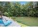 Serene pond with fountain feature and deck with lounge chairs at 1640 Settindown Dr, Roswell, GA 30075