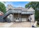 Charming home with a back porch and a garage beneath it in a wooded location at 1640 Settindown Dr, Roswell, GA 30075