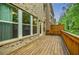 Spacious wood deck perfect for outdoor entertaining with a brick house and wooded background at 2464 Georgetown Ave, Atlanta, GA 30345