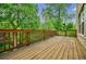 Relaxing back deck with wooden railing and wooded view at 2464 Georgetown Ave, Atlanta, GA 30345