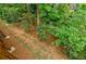 Overlooking a backyard filled with bushes and lush green trees from the back deck at 2464 Georgetown Ave, Atlanta, GA 30345