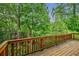 Overlooking the backyard from the back deck, the yard is surrounded by lush green trees at 2464 Georgetown Ave, Atlanta, GA 30345