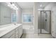 Bathroom with double vanity, soaking tub, and glass shower at 2464 Georgetown Ave, Atlanta, GA 30345