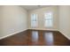 Bright, airy bedroom featuring hardwood floors and two windows, perfect for relaxation and natural light at 2464 Georgetown Ave, Atlanta, GA 30345