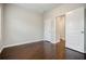 An empty bedroom with two white doors and hardwood floors at 2464 Georgetown Ave, Atlanta, GA 30345