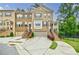 Charming brick townhome with a two-car garage, beautiful landscaping, and inviting front porch at 2464 Georgetown Ave, Atlanta, GA 30345