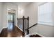 Upstairs hallway with hardwood floors, staircase and window at 2464 Georgetown Ave, Atlanta, GA 30345