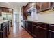 Modern kitchen with stainless steel appliances, granite countertops, and dark wood cabinetry at 2464 Georgetown Ave, Atlanta, GA 30345
