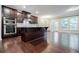 Bright kitchen with dark wood cabinets, granite counters, stainless appliances, and eat-in island at 2464 Georgetown Ave, Atlanta, GA 30345
