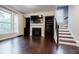 Living room with fireplace, built-in shelving and large windows with hardwood floors at 2464 Georgetown Ave, Atlanta, GA 30345