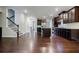 Open concept living room with dark wood cabinets, stainless appliances, and hardwood flooring at 2464 Georgetown Ave, Atlanta, GA 30345
