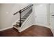 Elegant staircase with dark wood steps and banister and white risers leading to the upper level of the home at 2464 Georgetown Ave, Atlanta, GA 30345