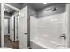 This bathroom showcases a tub with a shower, tiled walls and flooring, and a seating ledge at 2991 Black Bear Se Dr, Marietta, GA 30067