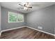 This bedroom has hardwood floors, a ceiling fan, and a window for natural light at 2991 Black Bear Se Dr, Marietta, GA 30067