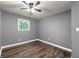 This cozy bedroom features hardwood floors, a ceiling fan, and a window providing natural light at 2991 Black Bear Se Dr, Marietta, GA 30067