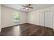 This bedroom features hardwood floors, a ceiling fan, and a closet for storage at 2991 Black Bear Se Dr, Marietta, GA 30067