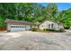 Ranch style home featuring attached two-car garage and mature landscaping at 2991 Black Bear Se Dr, Marietta, GA 30067