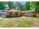 Traditional brick home featuring a lush, landscaped front yard and charming architectural details at 2991 Black Bear Se Dr, Marietta, GA 30067